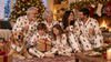 Family, children and dog enjoying Christmas in personalized matching pajamas