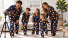Family preparing an at-home photoshoot in matching personalized pajama sets
