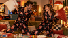 Couple laughing in funny matching personalized pajamas during game night