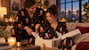 Couple opening a personalized his and hers pajama gift