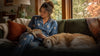 Dog owner relaxing naturally beside their dog while wearing pajamas inspired by the pet portrait