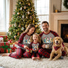 Family and Dog Wearing Matching Christmas Pajamas by Christmas Tree on Holiday Morning