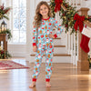 Girl in the child-size aqua cocoa mug and cookie Christmas pajama set with red ribbed cuffs