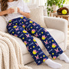 Woman wearing navy personalized softball pajama pants in lounge style, relaxing in a cozy living room